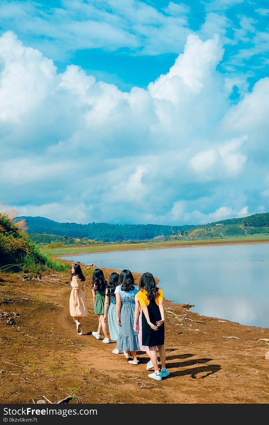 Women Near Calm Body Of Water