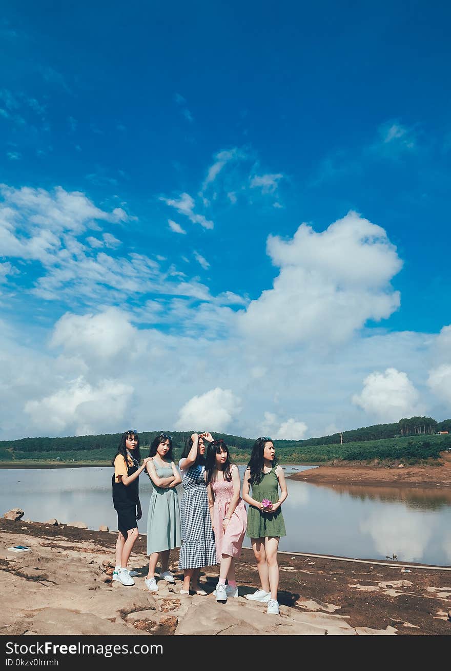 Women Standing Near Body Of Water