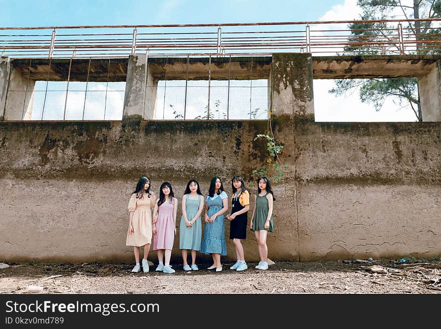 Six Women Standing Near Wall