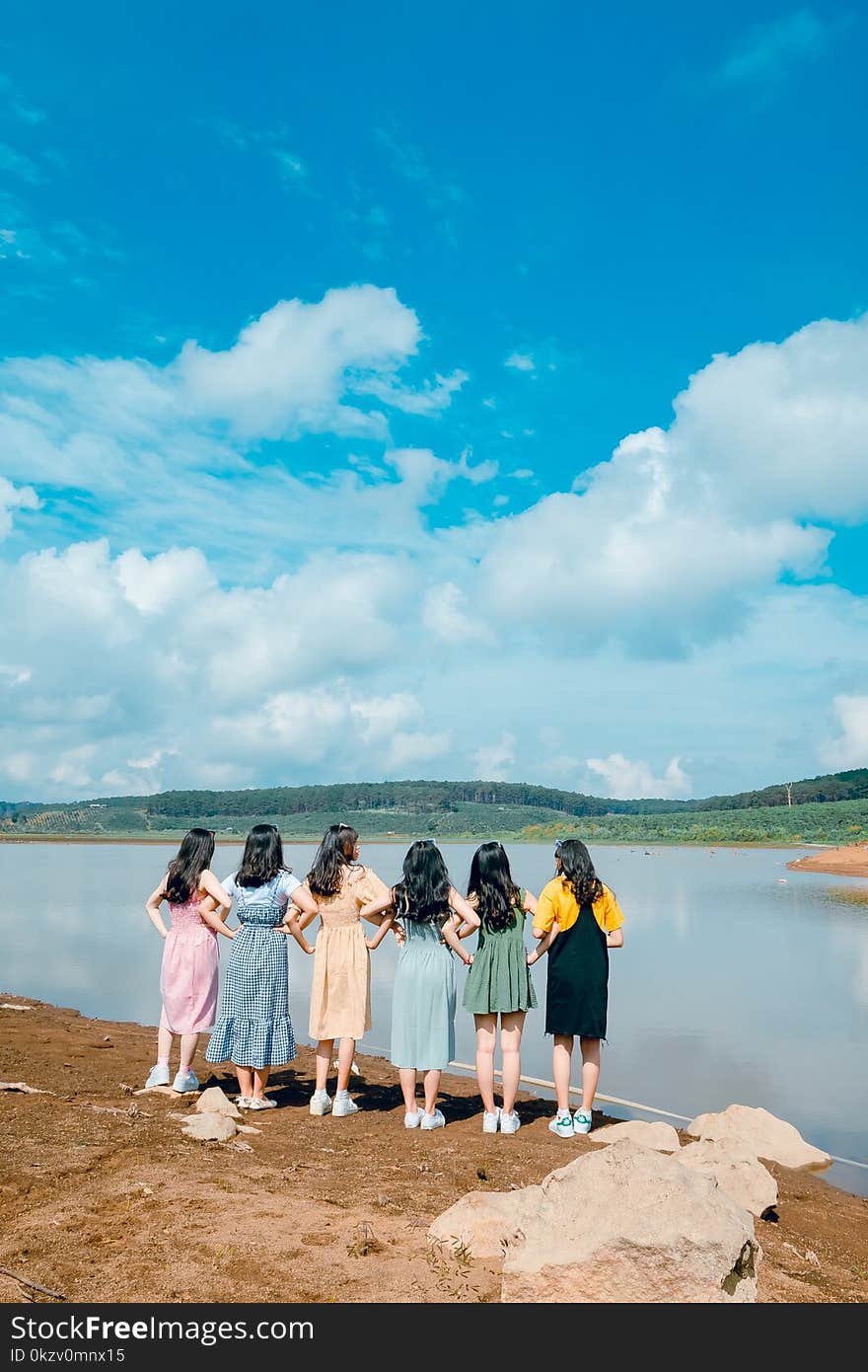 Six Women Facing Body of Water Taking Picture