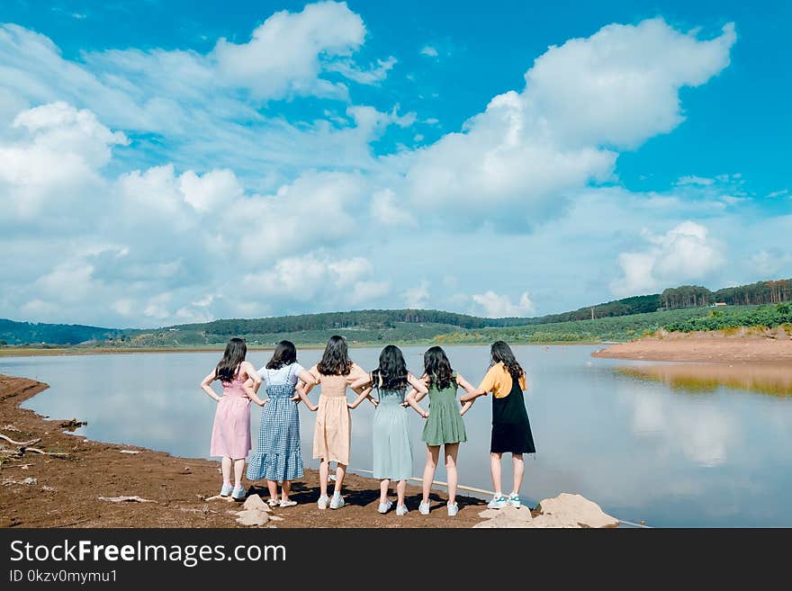 Group of Girls Standing Beside River