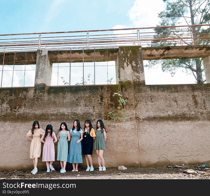 Group of Women Standing Infront of Wall