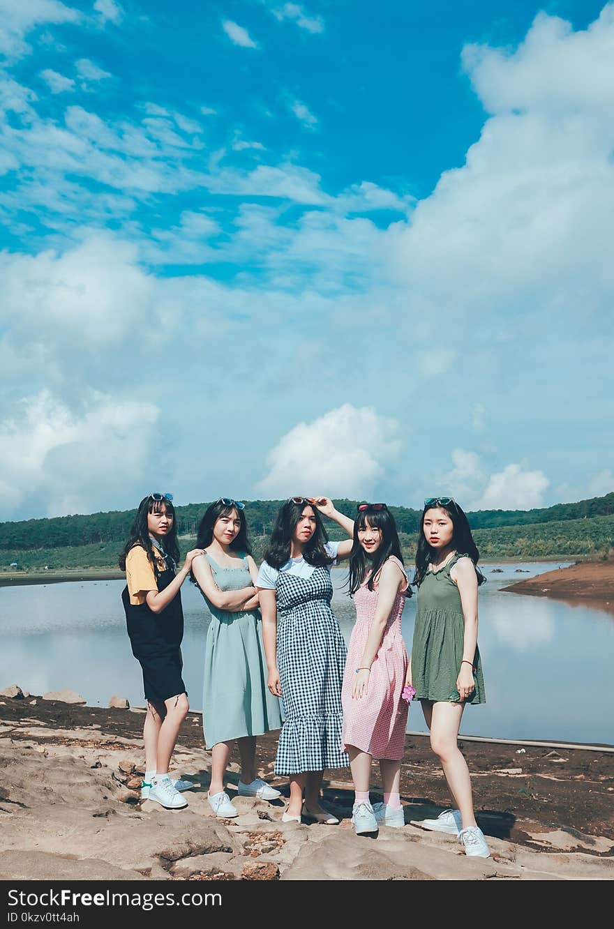 Women Standing Near Body Of Water