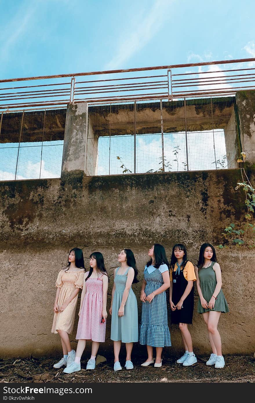 Six Women Stands in Front of Gray Concrete Wall