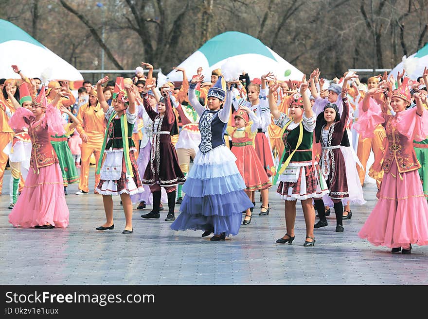 Women and Girls Wearing Traditional Dresses Holding Up Two Hands