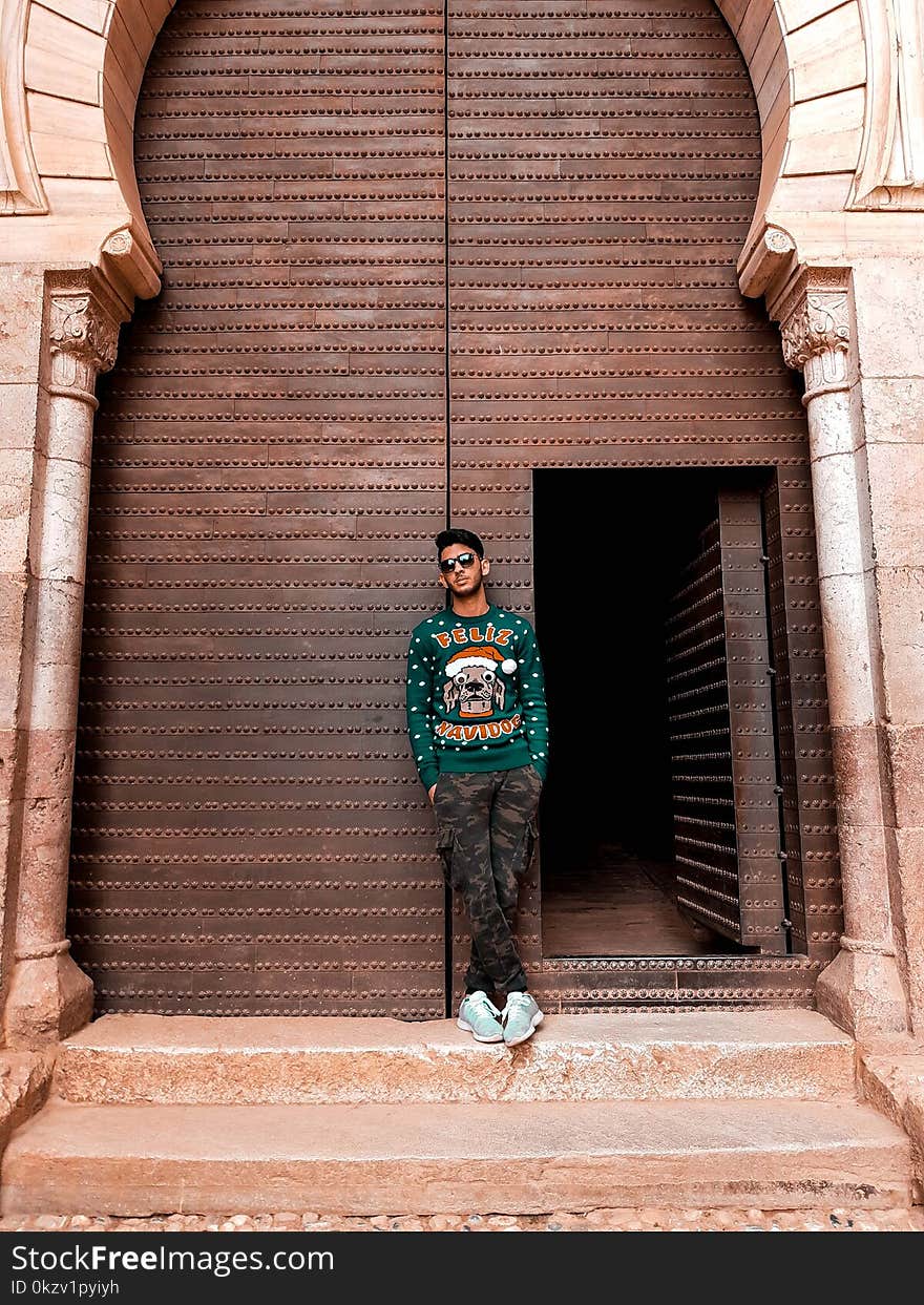 Man In Green Long-sleeved Top And Camouflage Pants