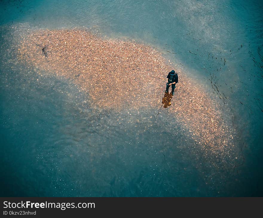 Man Wearing Black Top in Body of Water