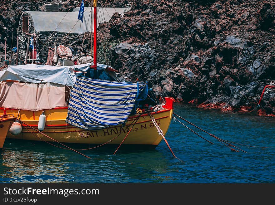 Yellow and Red Boat on Body of Water