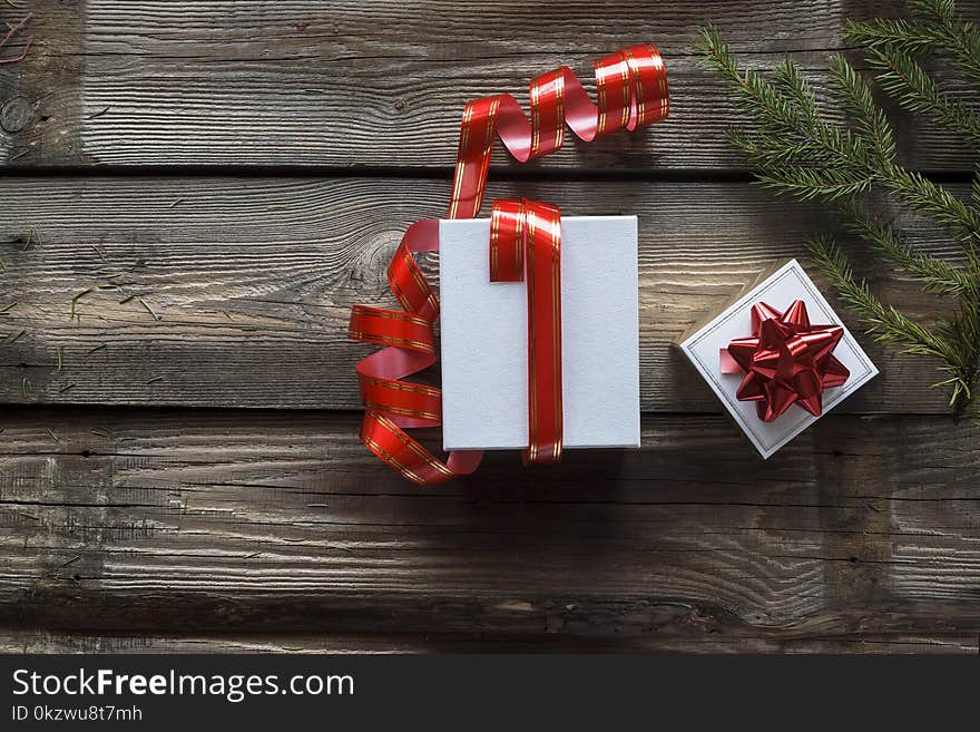 Christmas, New year. top view white gift boxes and red ribbon on wood background with space. Vintage gift box on wooden board with space for text. online delivery. Christmas, New year. top view white gift boxes and red ribbon on wood background with space. Vintage gift box on wooden board with space for text. online delivery