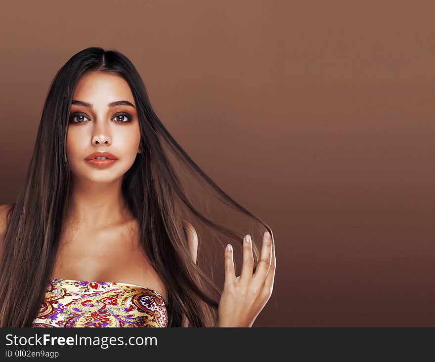 Cute happy young indian woman in studio close up smiling, fashion mulatto beauty warm