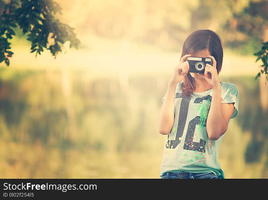 Pretty photographer girl with vintage camera.