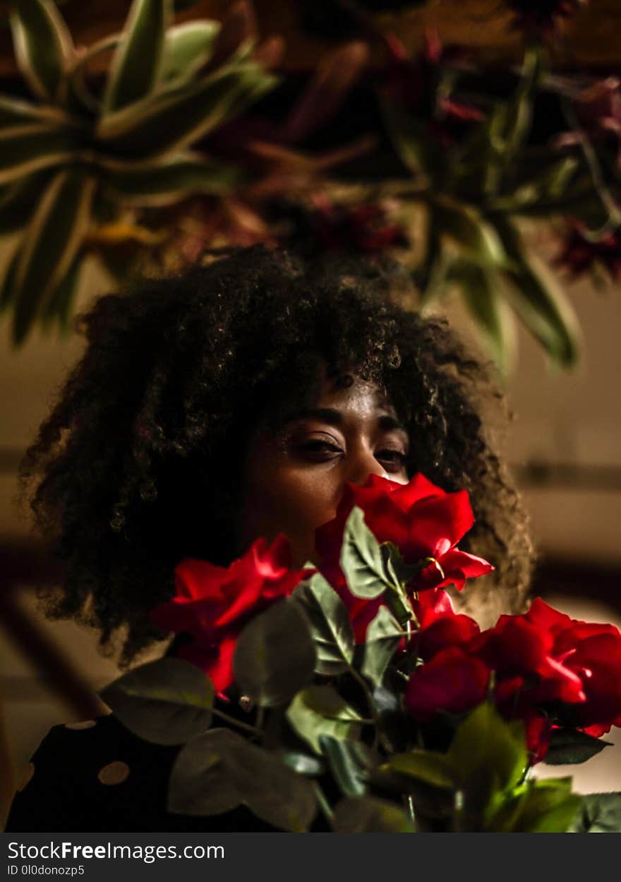 Woman Behind Red Flowers