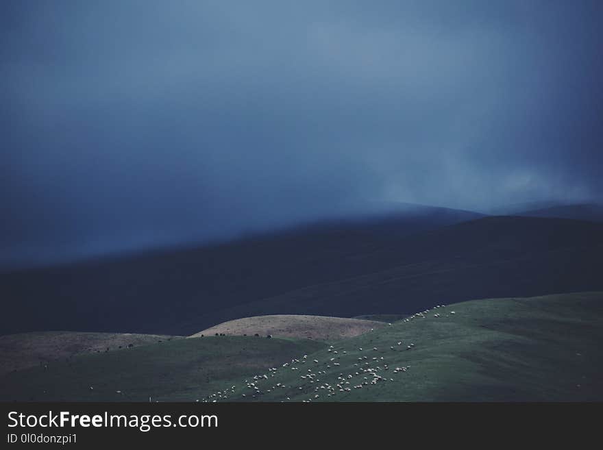 Mountain Range Under Cloudy Sky