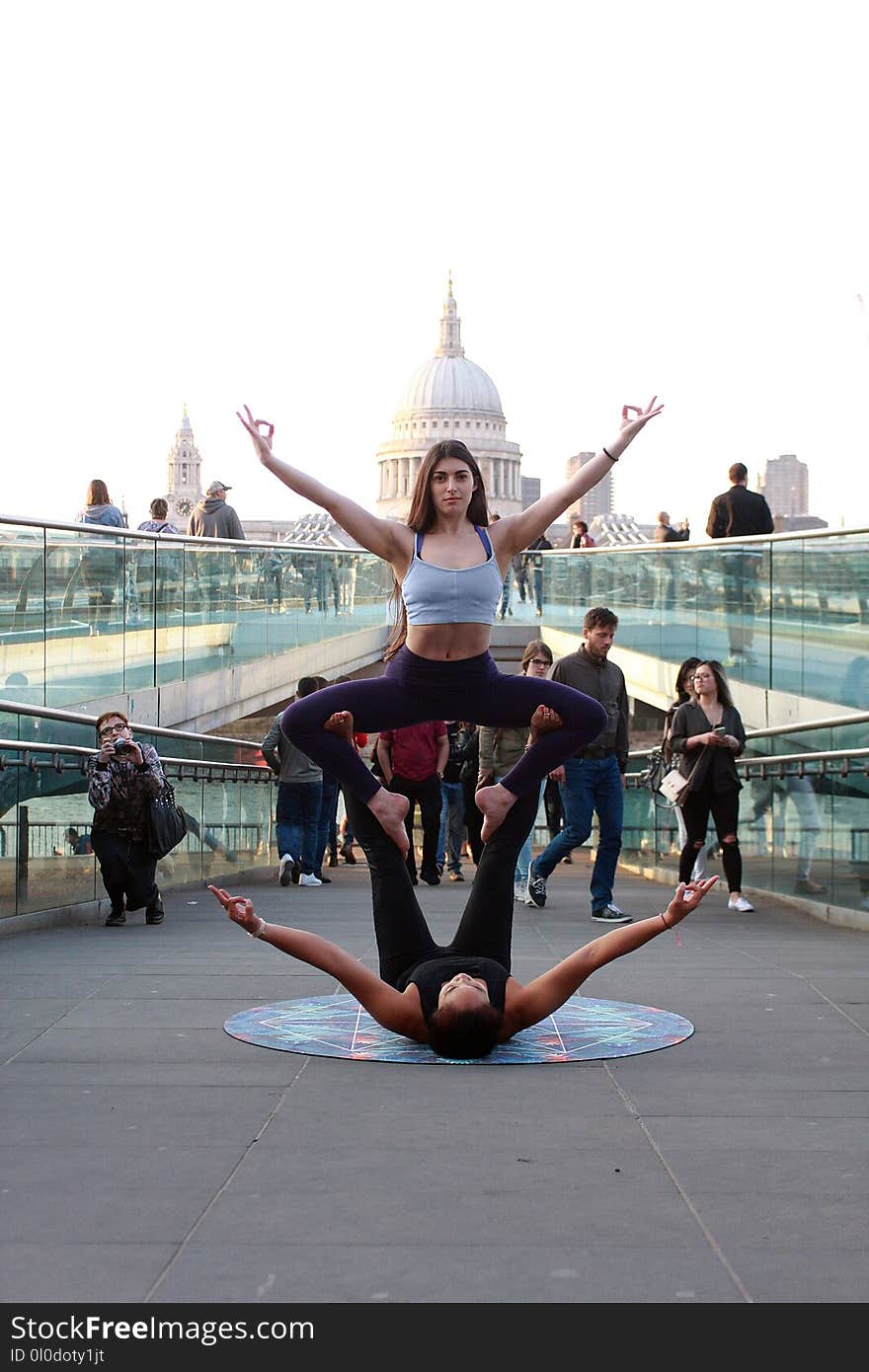 Two Women Performing Yoga on Street at Daytime