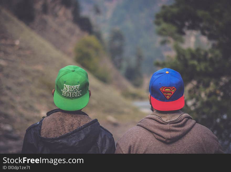 Shallow Focus Photography of Two Men Wearing Caps