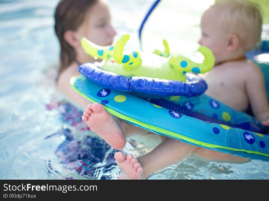 Baby on Blue and Green Personal Flotation Device