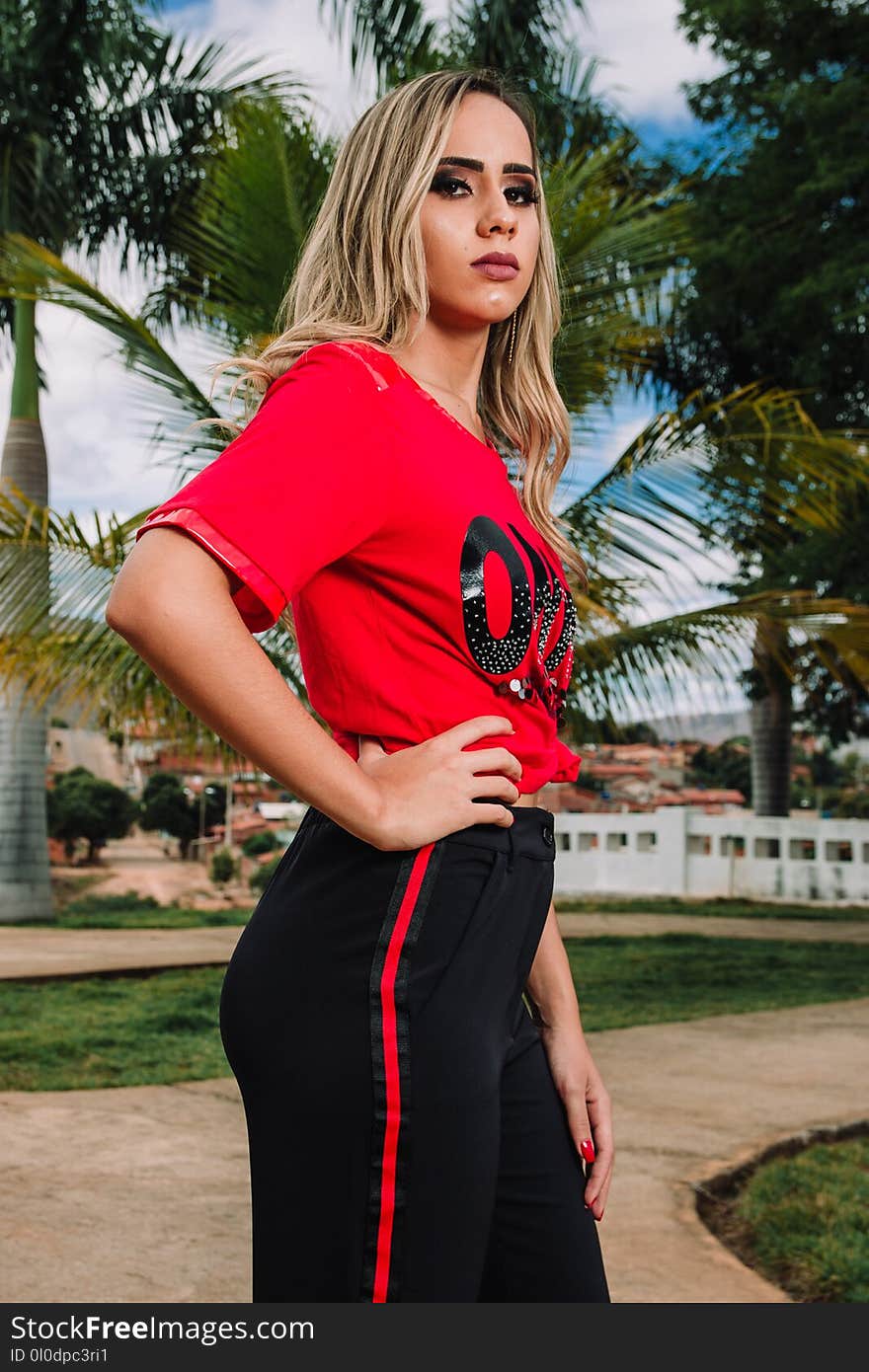 Woman in Red T-shirt and Black Pants