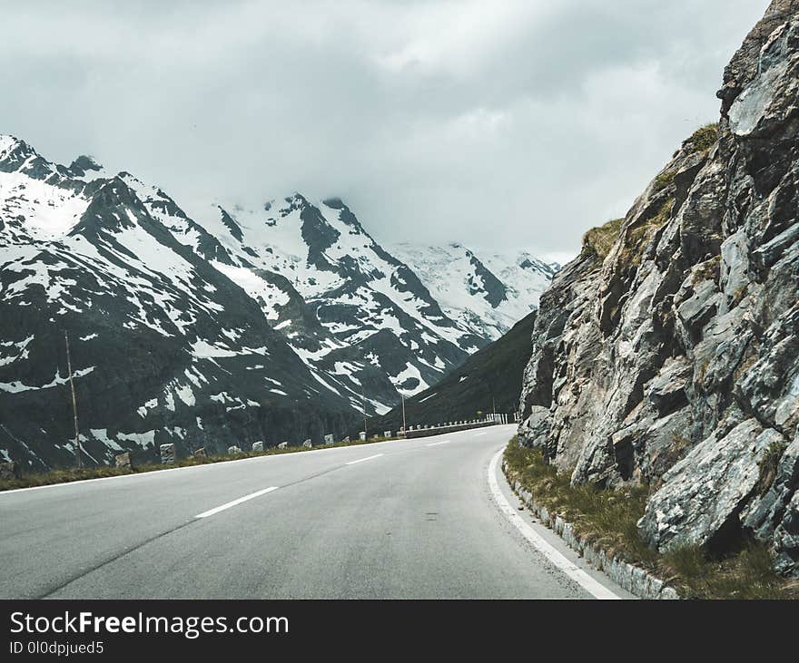 Concrete Road Surrounded Mountains during Golden Hour