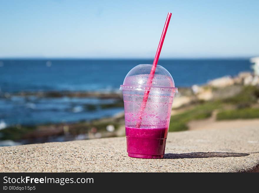 Clear Plastic Cup on Gray Concrete Surface