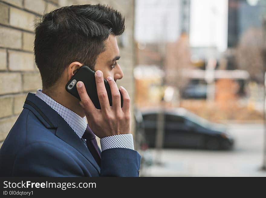 Man in Blue Suit Holding Smartphone