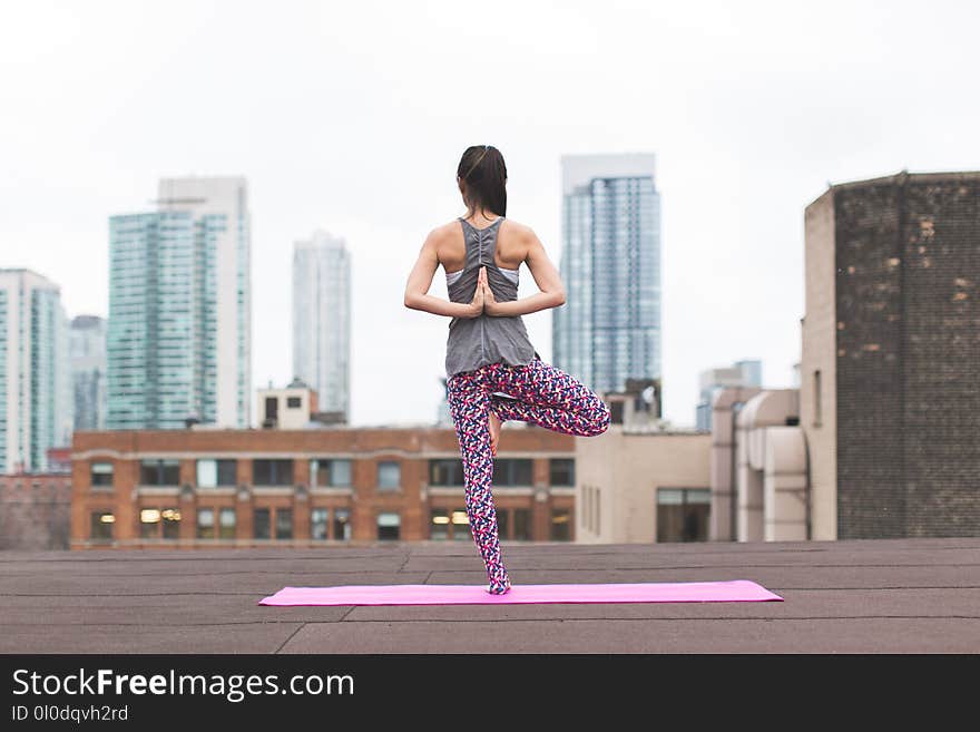 Woman Standing on Pink Yoga Mat Meditating