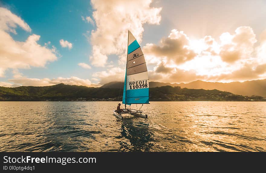 White Sailing Boat on Body of Water