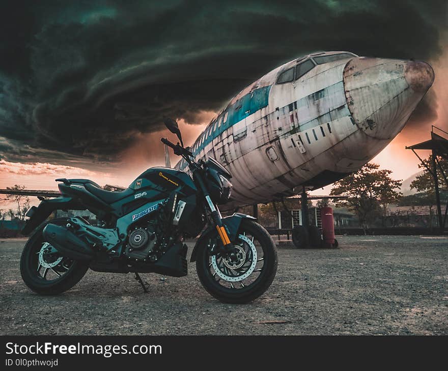 Photo of Motorcycle Near Airplane