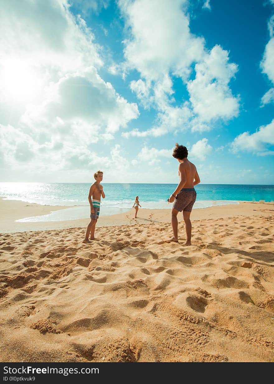 Group of People on Brown Sand