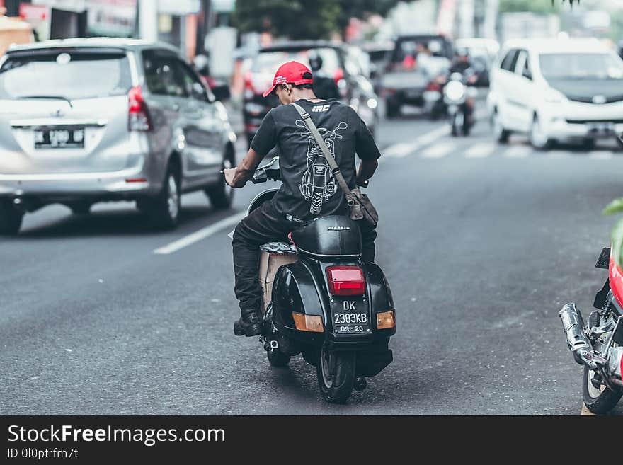 Photo of Man Riding Motorcycle on the Road