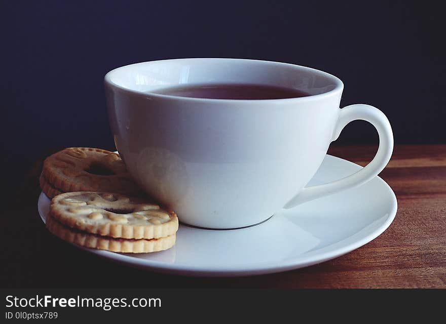 Close-up Photography of Cup of Coffee Near Biscuits