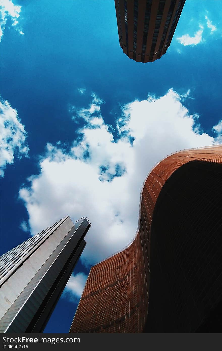 Brown and White Concrete Buildings Under Blue Sky Photography