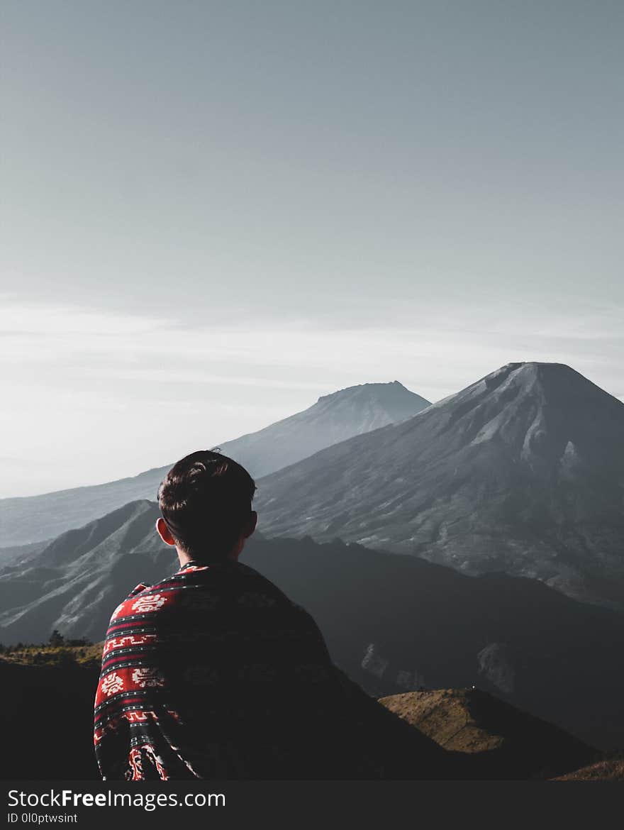 Photo of Person Atop Mountains