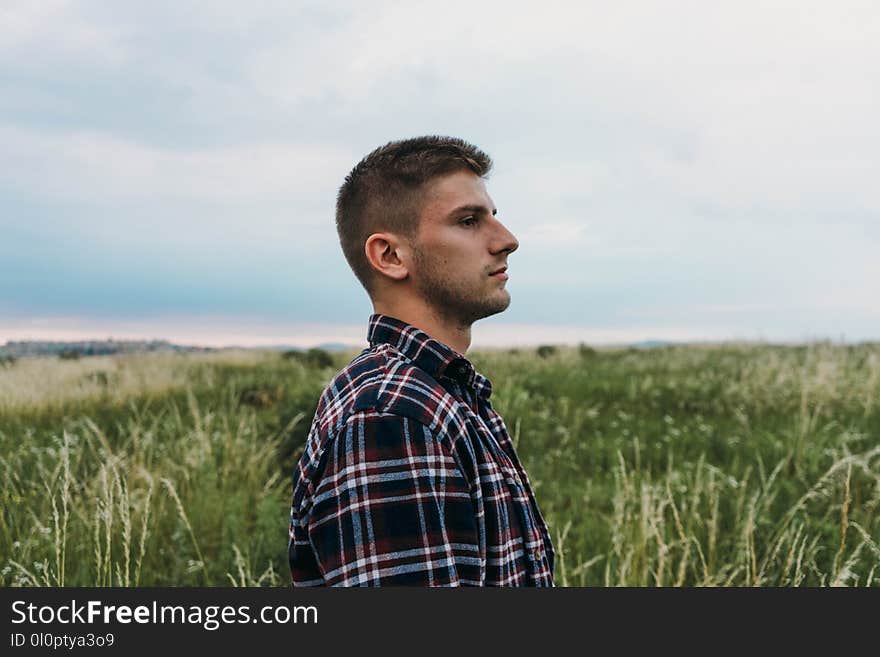 Man Standing on Grass Field