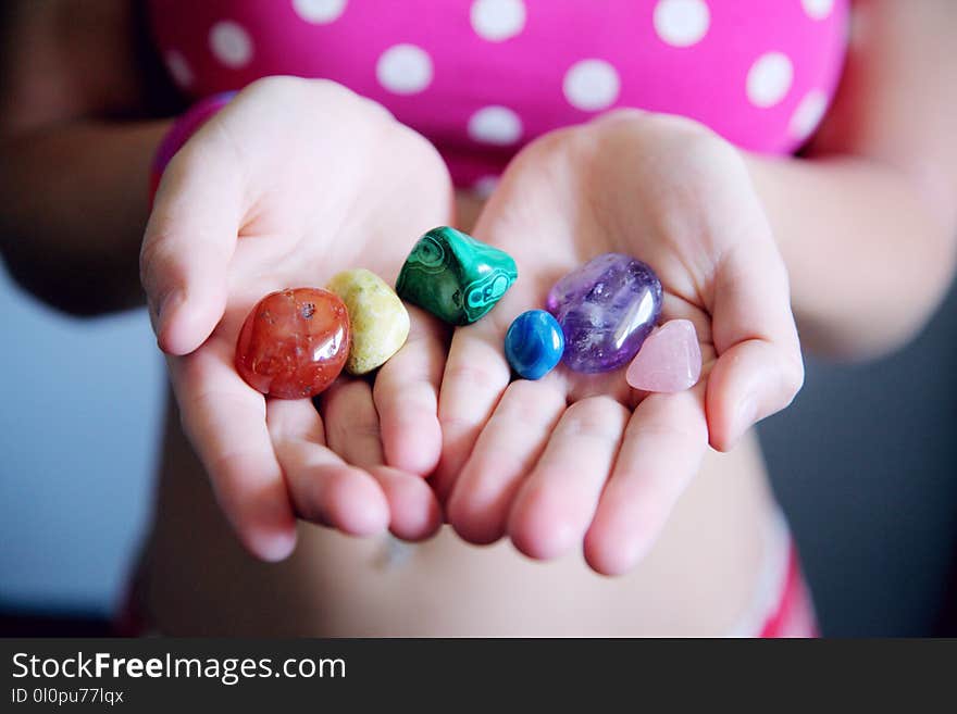 Woman Holding Six Polished Stones