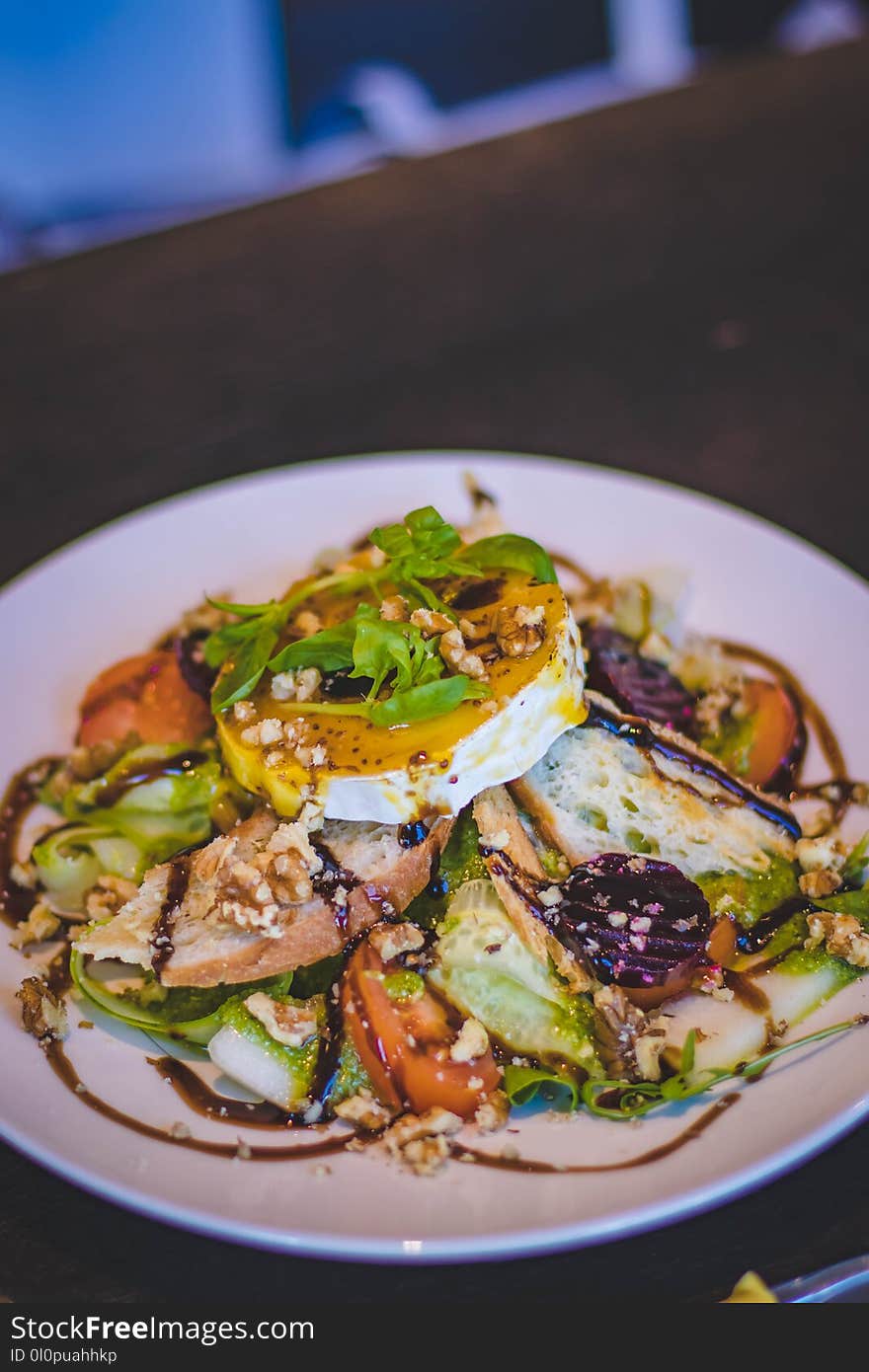 Food With Leaf Toppings on White Ceramic Plate