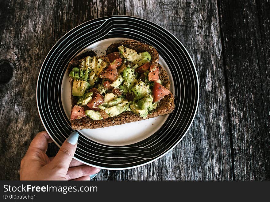 Person Holding Plate With Food