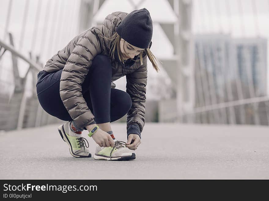 Photo of Woman Tying Her Shoe