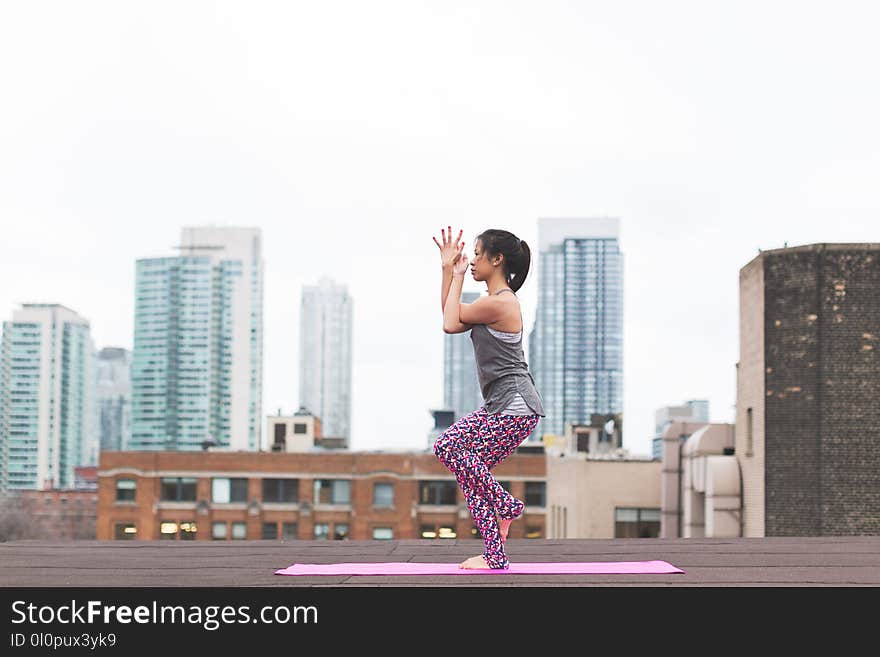 Photo of Woman Wearing Gray Tank Top and Purple Floral Pants