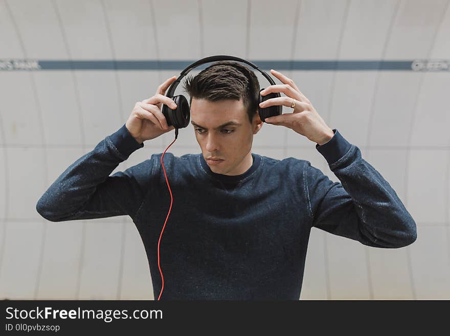 Man in Black Sweater Wearing Black Headphones