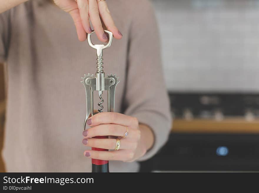 Person Holding Grey and Red Hand Tool