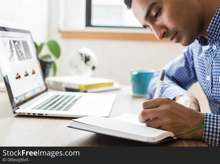 Man Using Ballpoint Pen