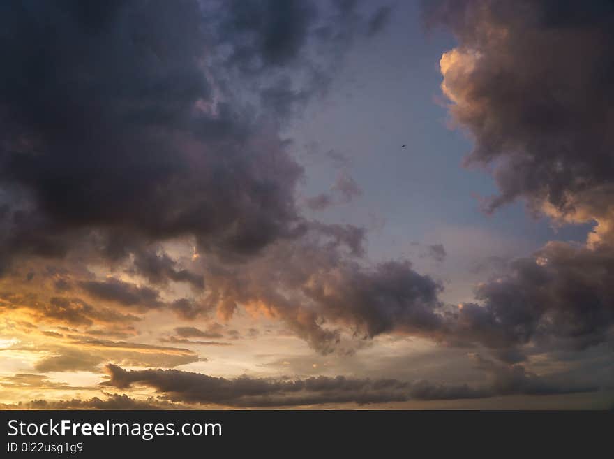 A small plane fly to the raining sky at sunset time. A small plane fly to the raining sky at sunset time