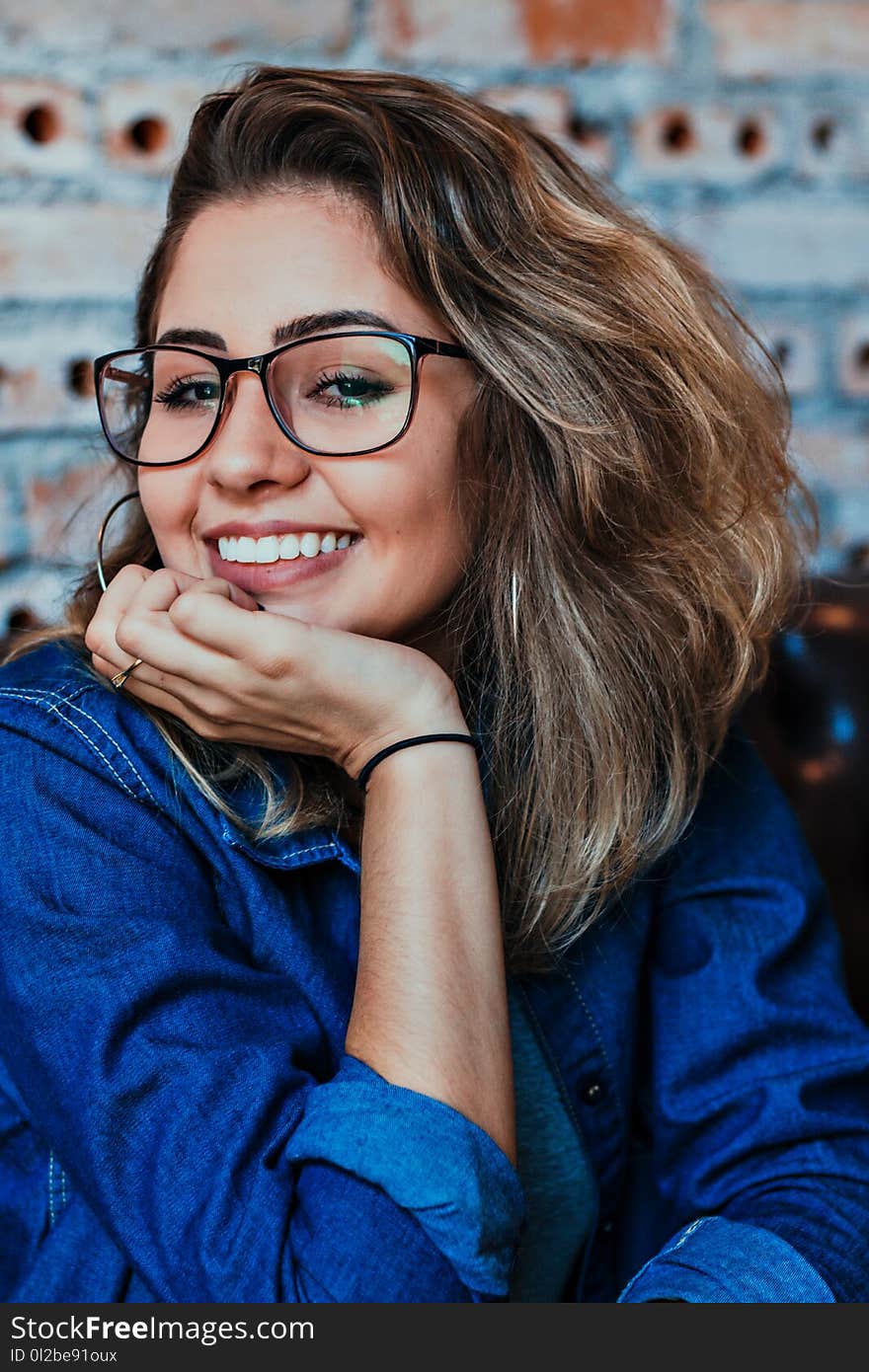 Closeup Photo of Smiling Woman Wearing Blue Denim Jacket