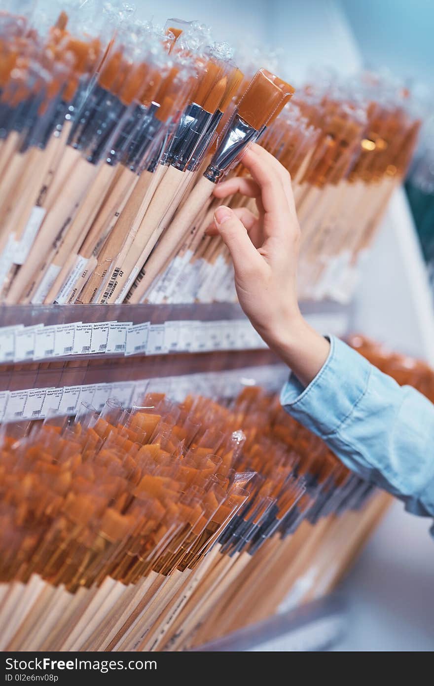 Young girl choosing an art brush close-up