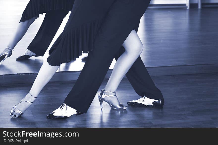 Ballroom dance couple of dancers and teachers in studio school dancing in rehearsal. Ballroom dance couple of dancers and teachers in studio school dancing in rehearsal.