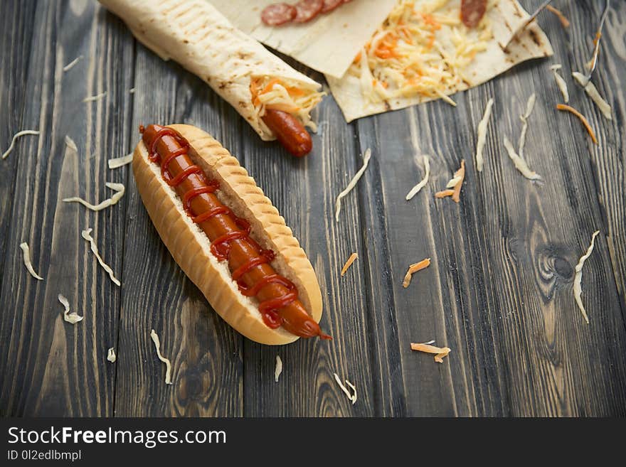 Fast food.hot dogs with sauce on wooden background.