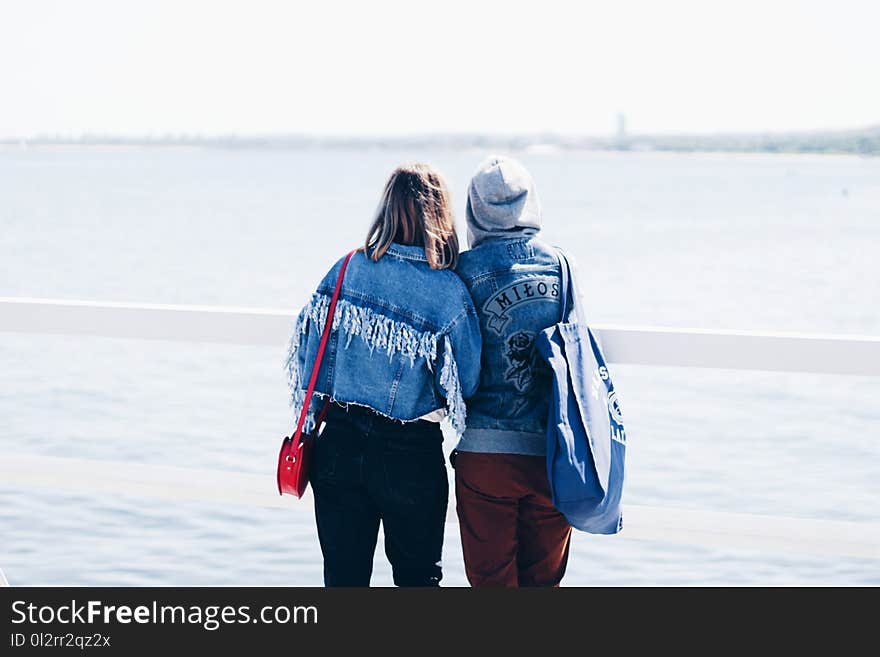 Two People Looking at the Beach