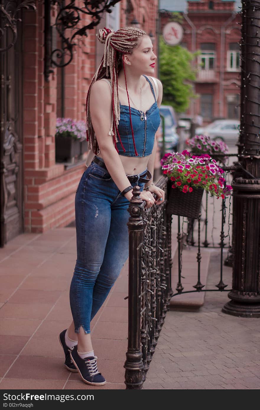 Woman Wearing Blue Crop Top Holding Handrails