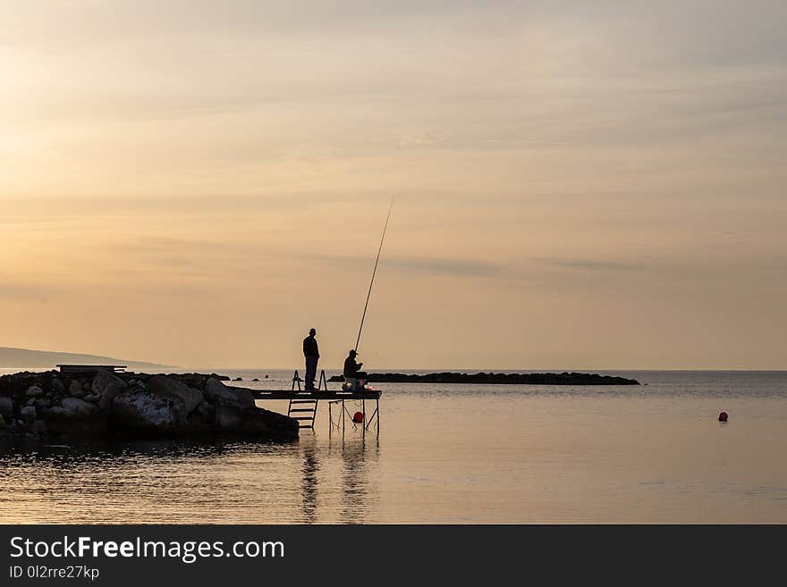 Two Person Having Fishing on Dock