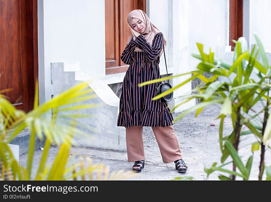 Woman Wearing Abaya Dress and Standing on Ground